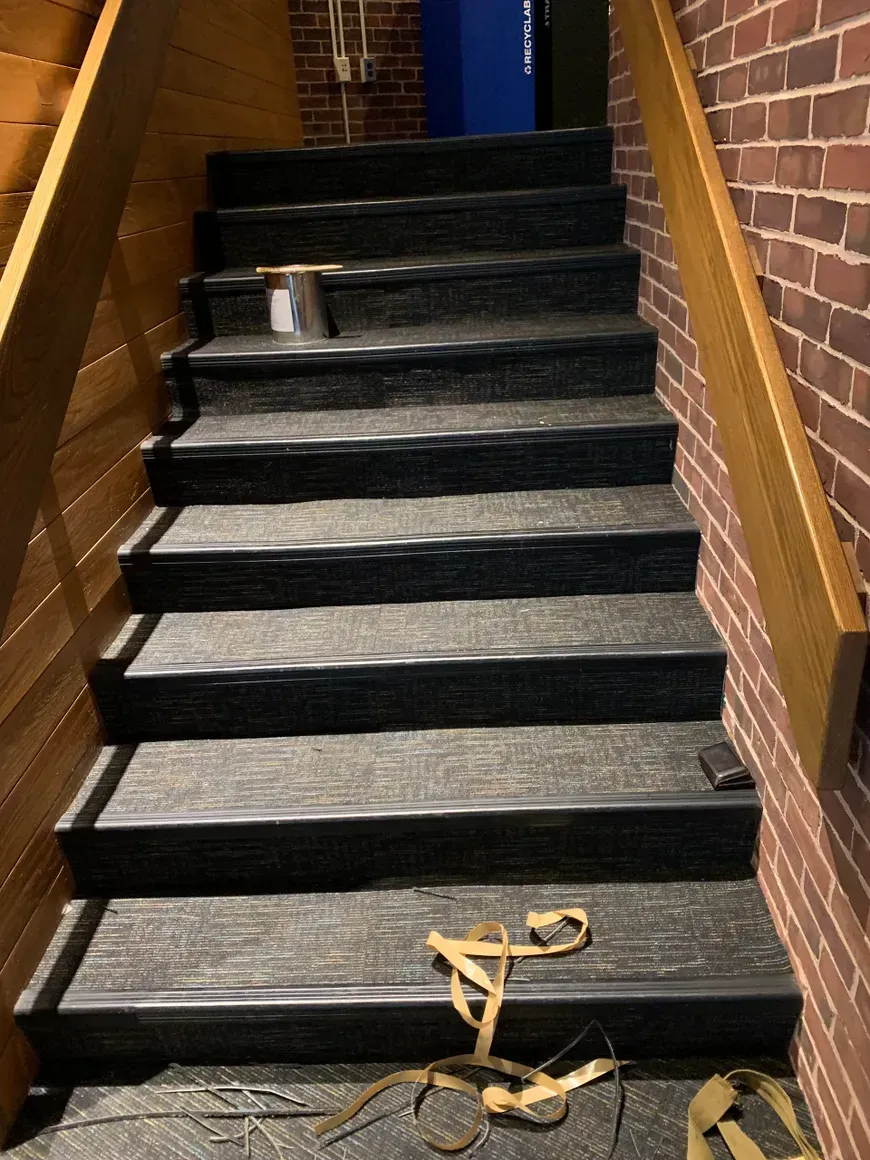 A set of stairs leading up to a brick wall.