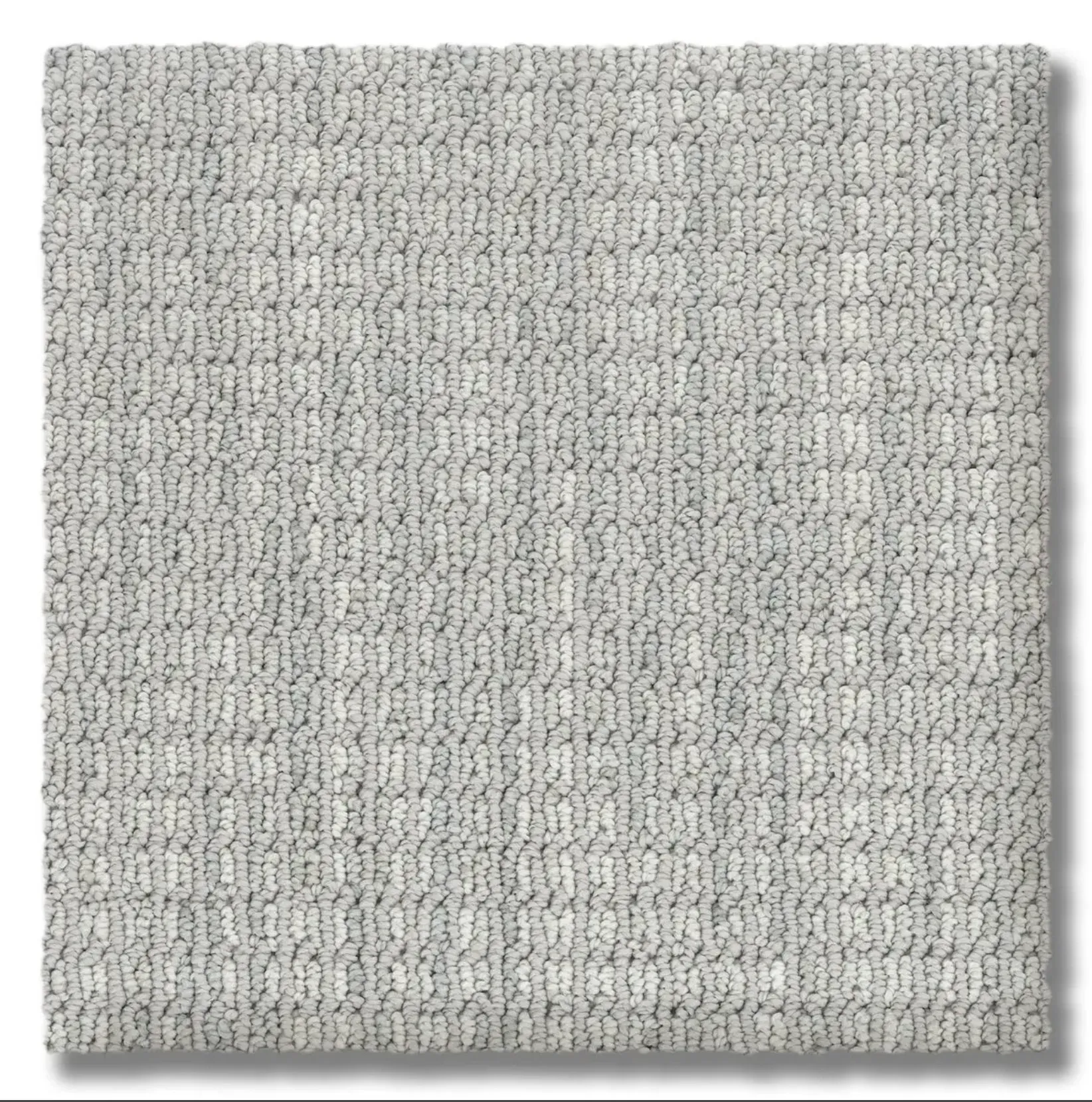 Light gray carpet sample with a textured, looped pattern.