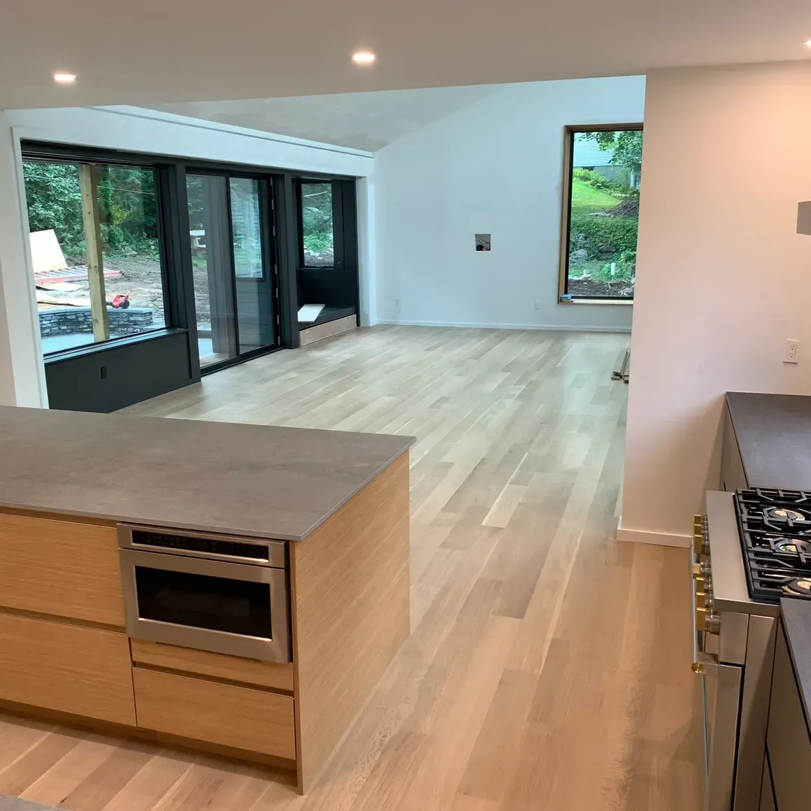 A kitchen with wooden floors and stainless steel appliances