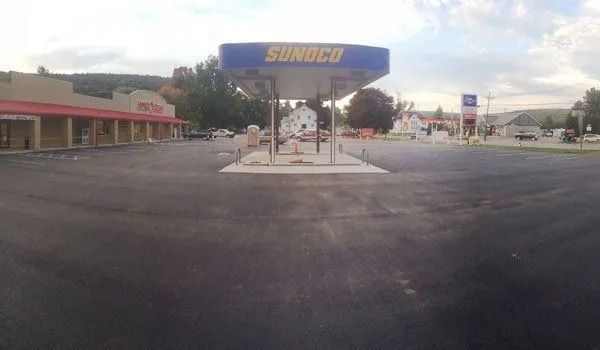 A Sunoco gas station with a vacant forecourt under an overcast sky.