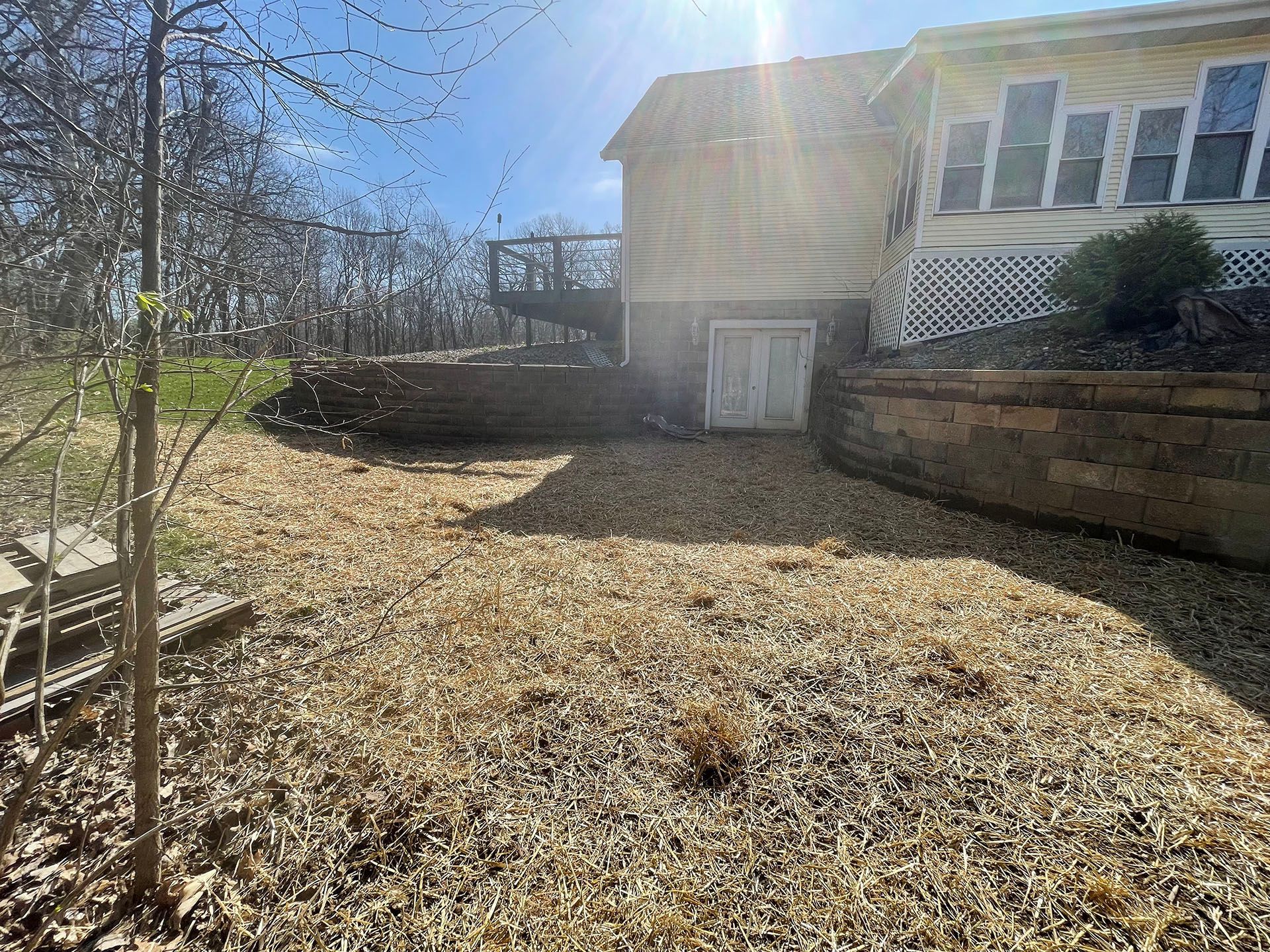 a large house with a lot of leaves on the ground in front of it
