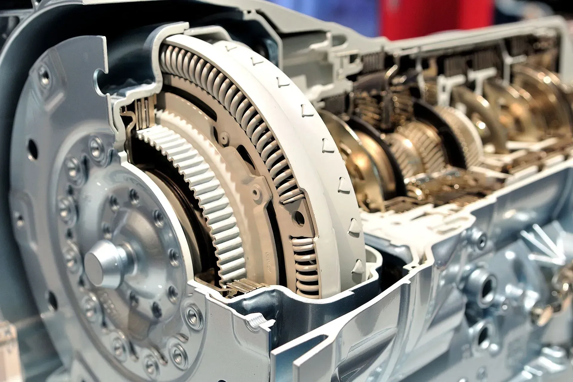 Bus axle assembly removed, lying on a garage floor next to the bus.