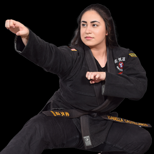 Woman in black martial arts uniform in a fighting stance, fists raised. Black belt, focused expression.