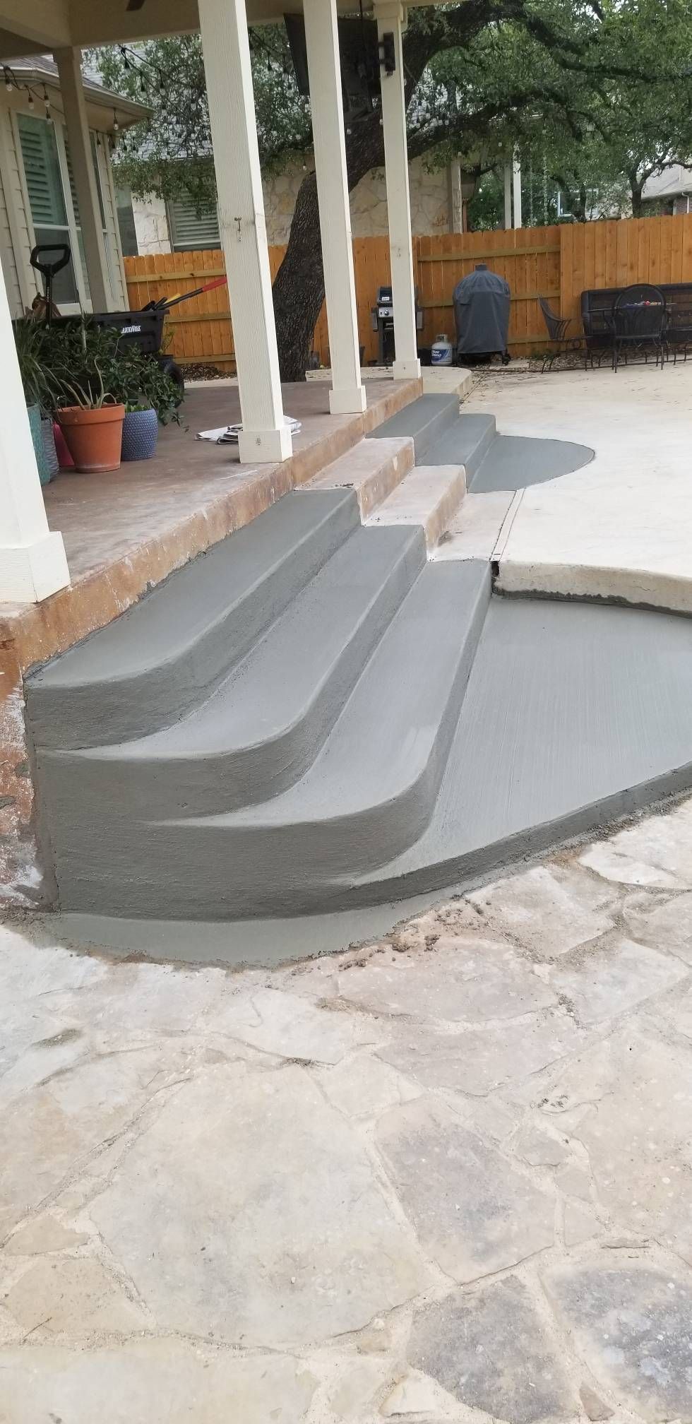 a set of concrete steps leading up to a porch