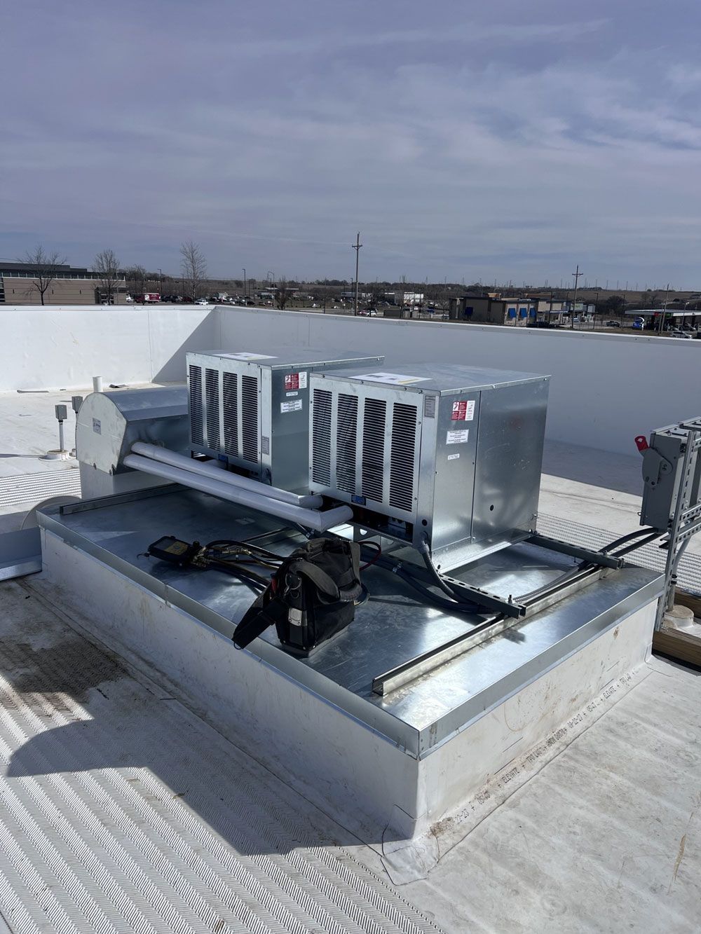 A roof with a lot of air conditioners on it