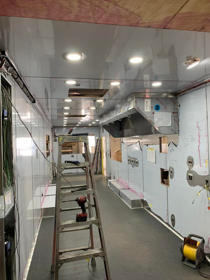 A ladder is sitting in the middle of a room.