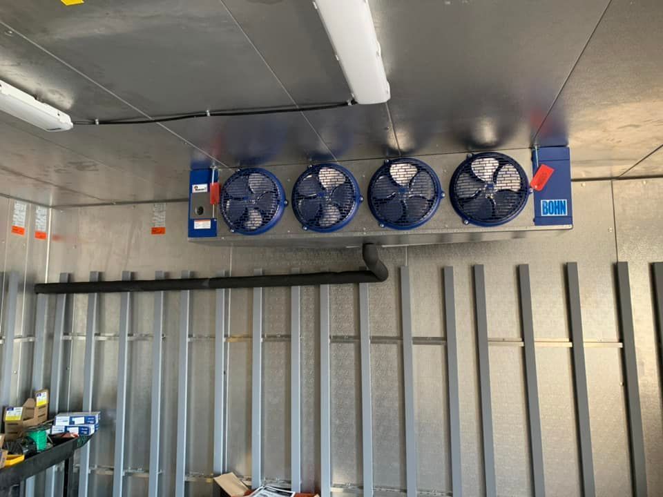 A room with a lot of fans hanging from the ceiling