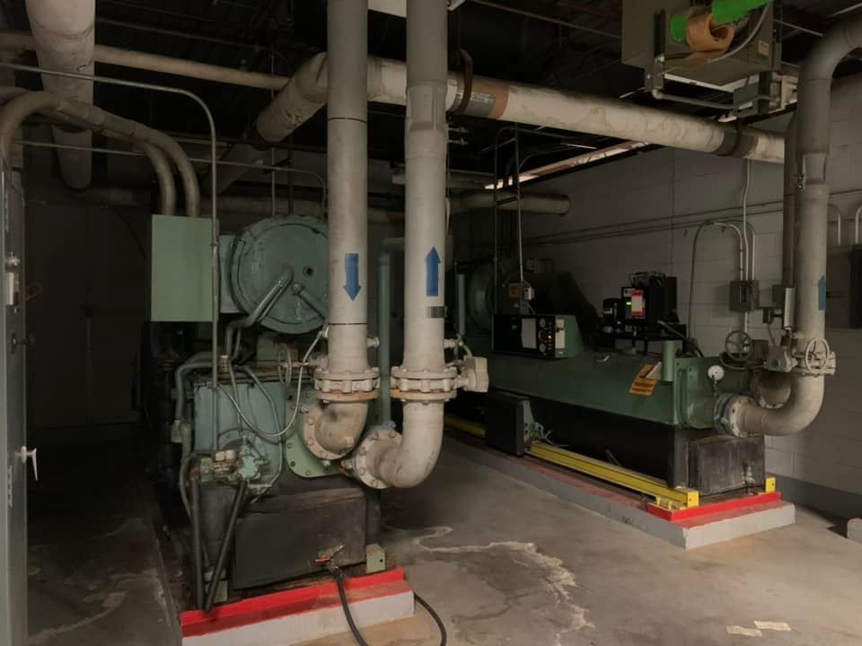 A room with a lot of pipes and machinery in it