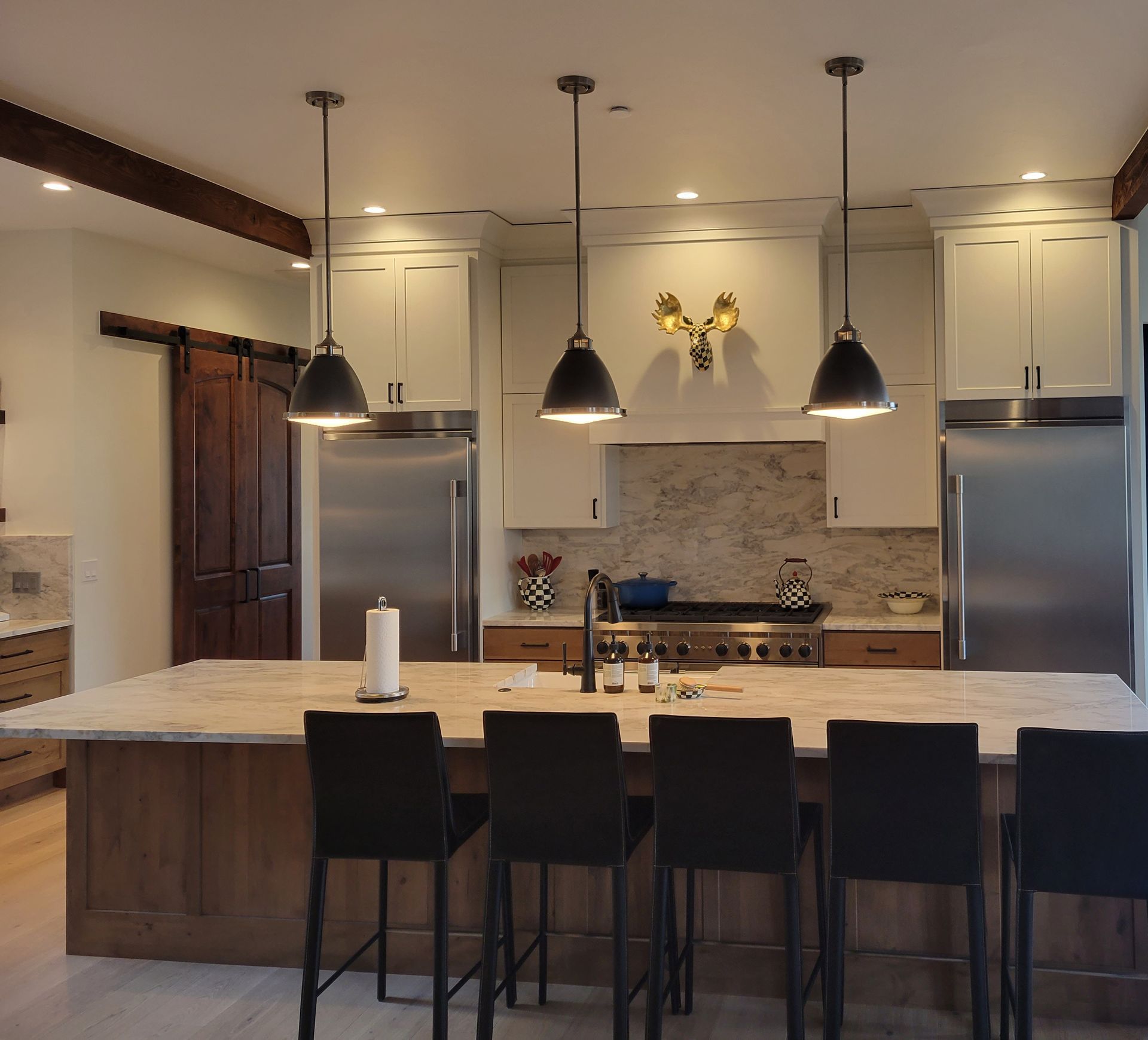 A kitchen with white cabinets and stainless steel appliances