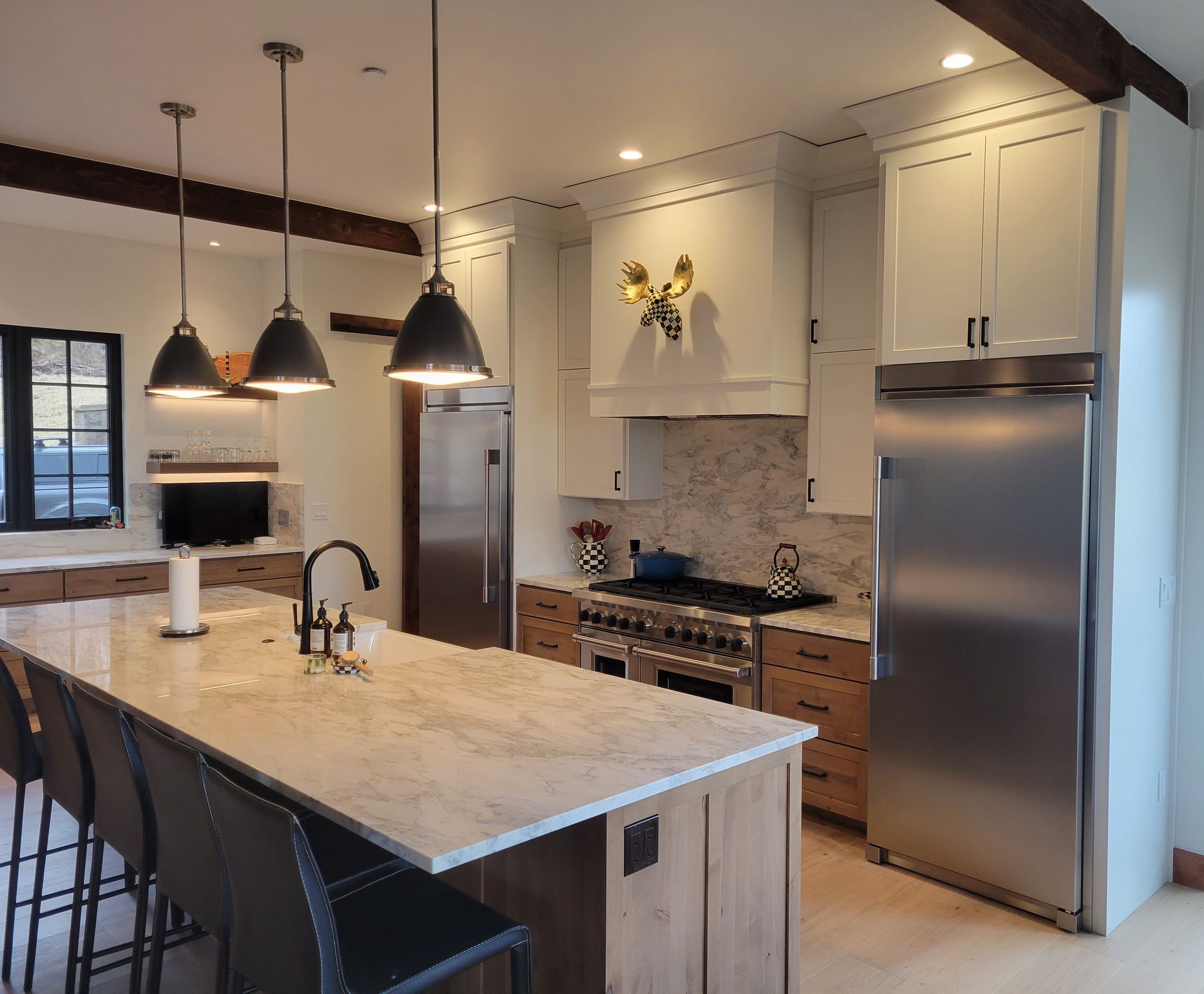 A kitchen with a large island and stainless steel appliances