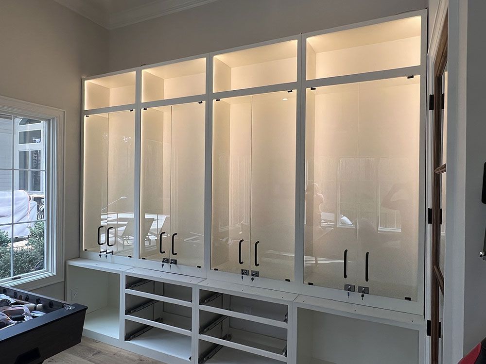 A room with a lot of cabinets and shelves and a window.