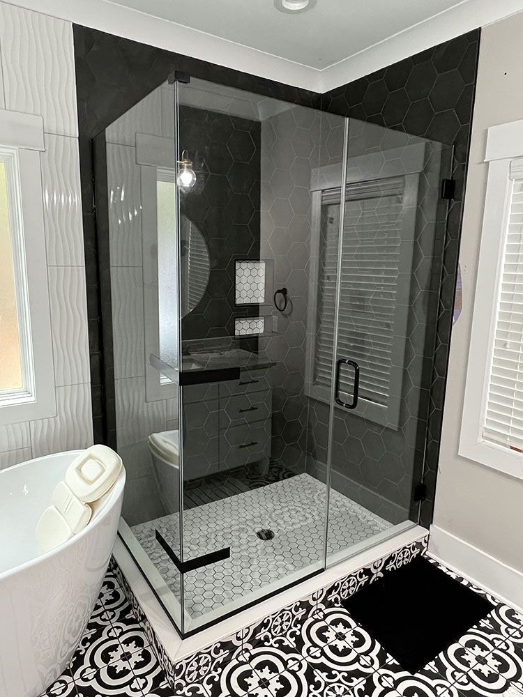 A bathroom with a walk in shower and a bathtub.