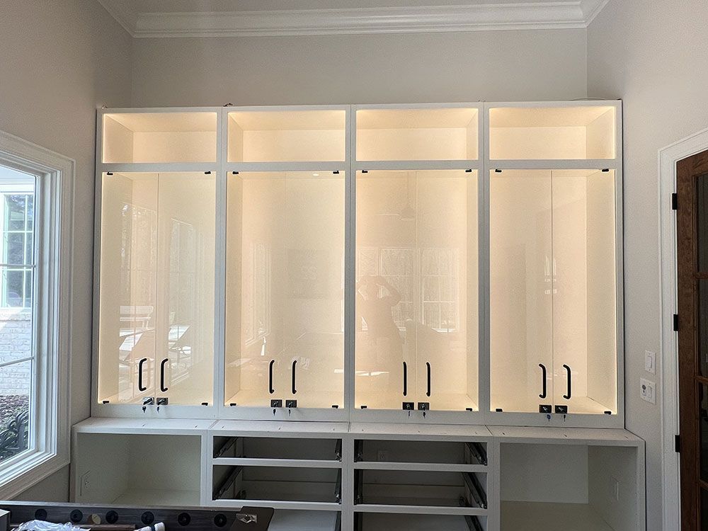 A room with a lot of cabinets and shelves and a window.