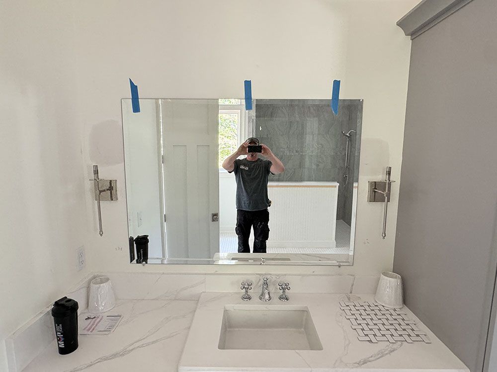 A man is taking a picture of himself in a bathroom mirror.