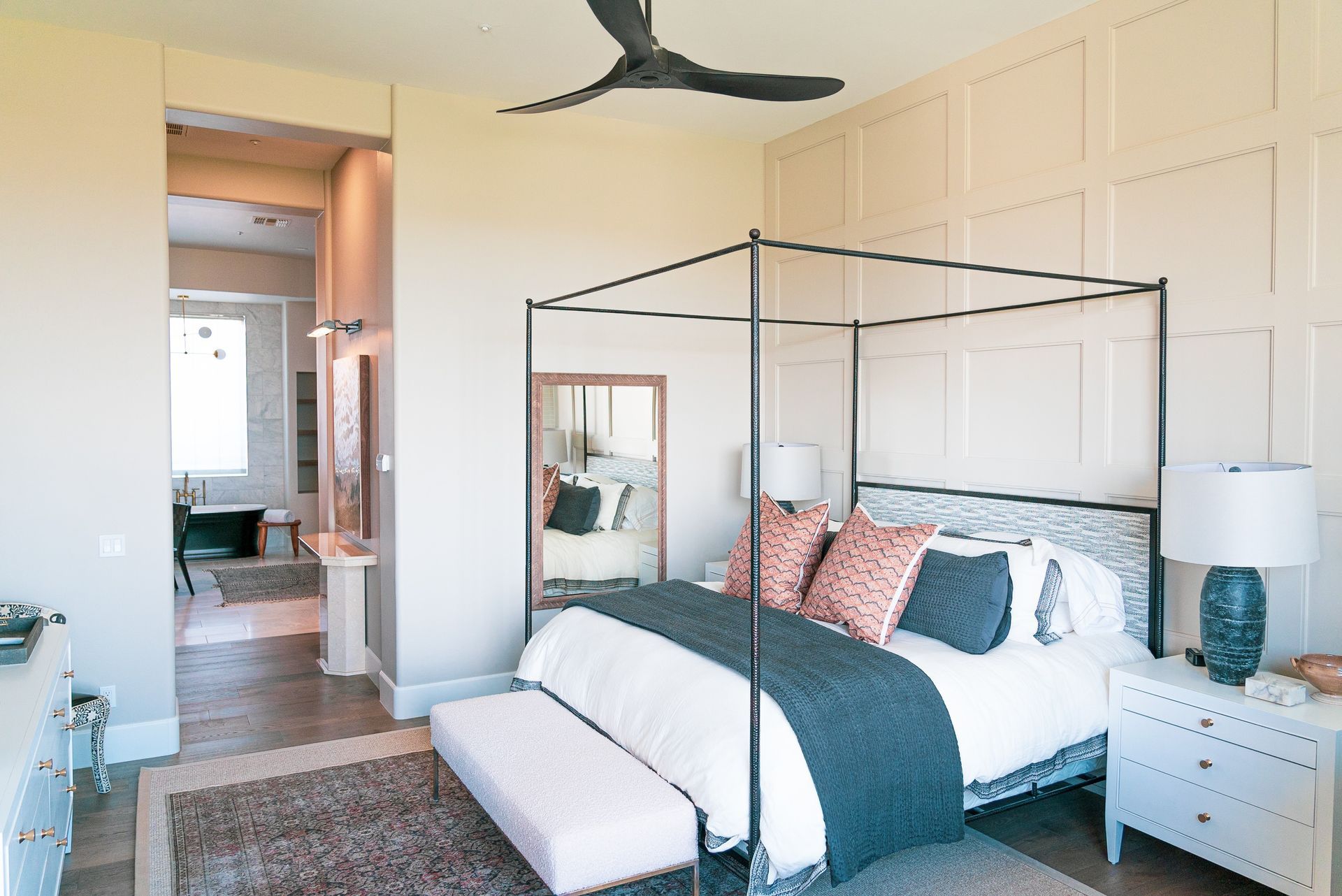 A bedroom with a canopy bed and a ceiling fan.