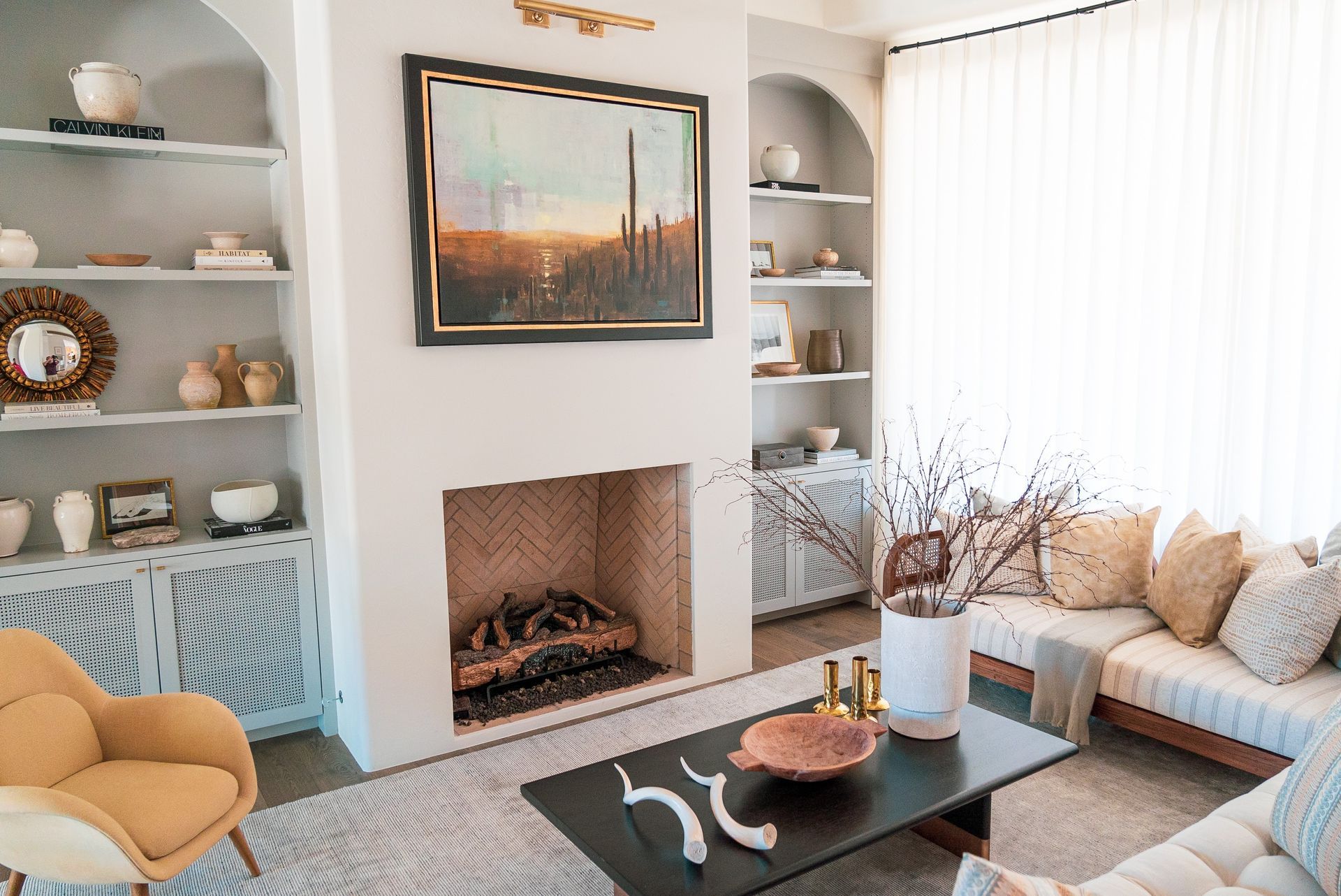 A living room with a fireplace , couch , chair and coffee table.