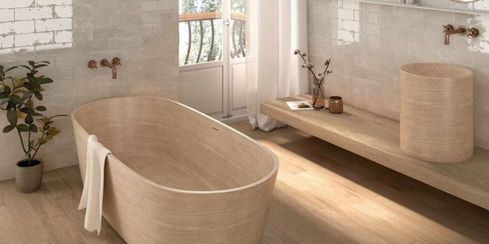 A bathroom with a wooden bathtub and a wooden sink.