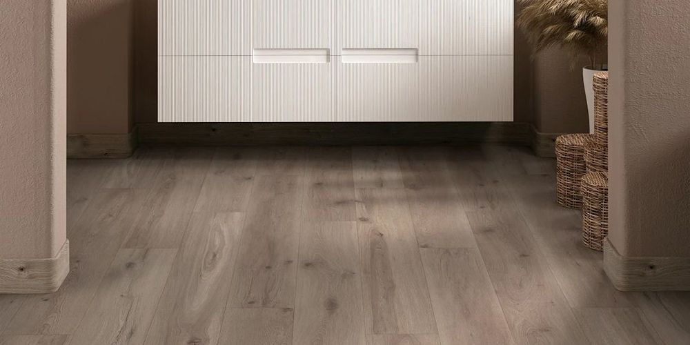A hallway with a wooden floor and a white cabinet.