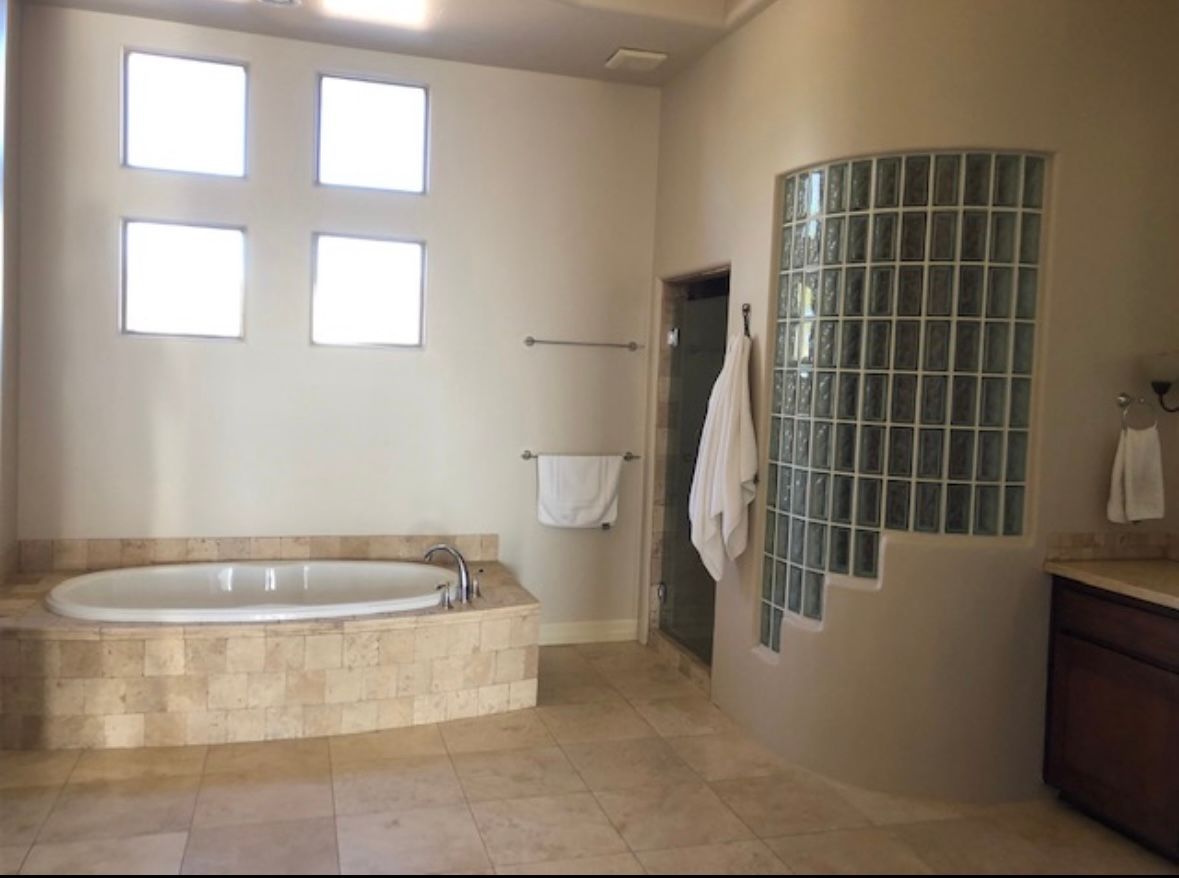A bathroom with a tub and a walk in shower