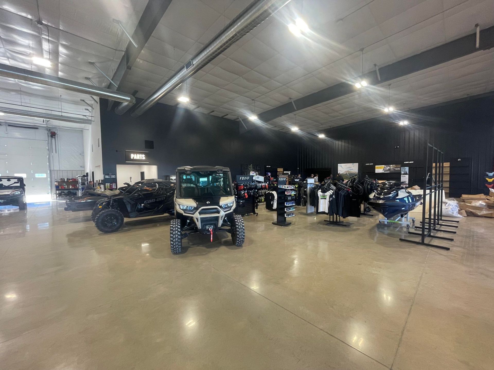 A large warehouse filled with lots of vehicles and watercrafts