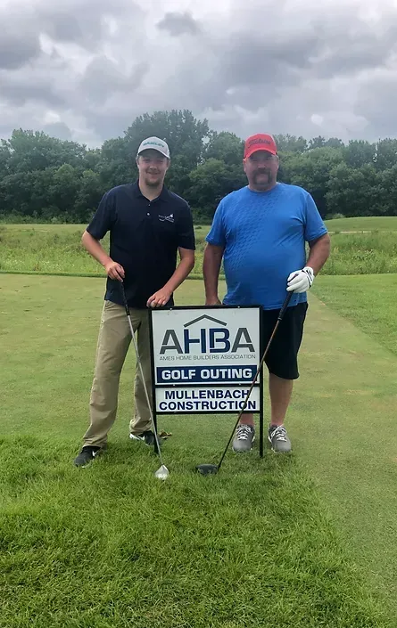 two men are standing next to each other on a golf course holding golf clubs 