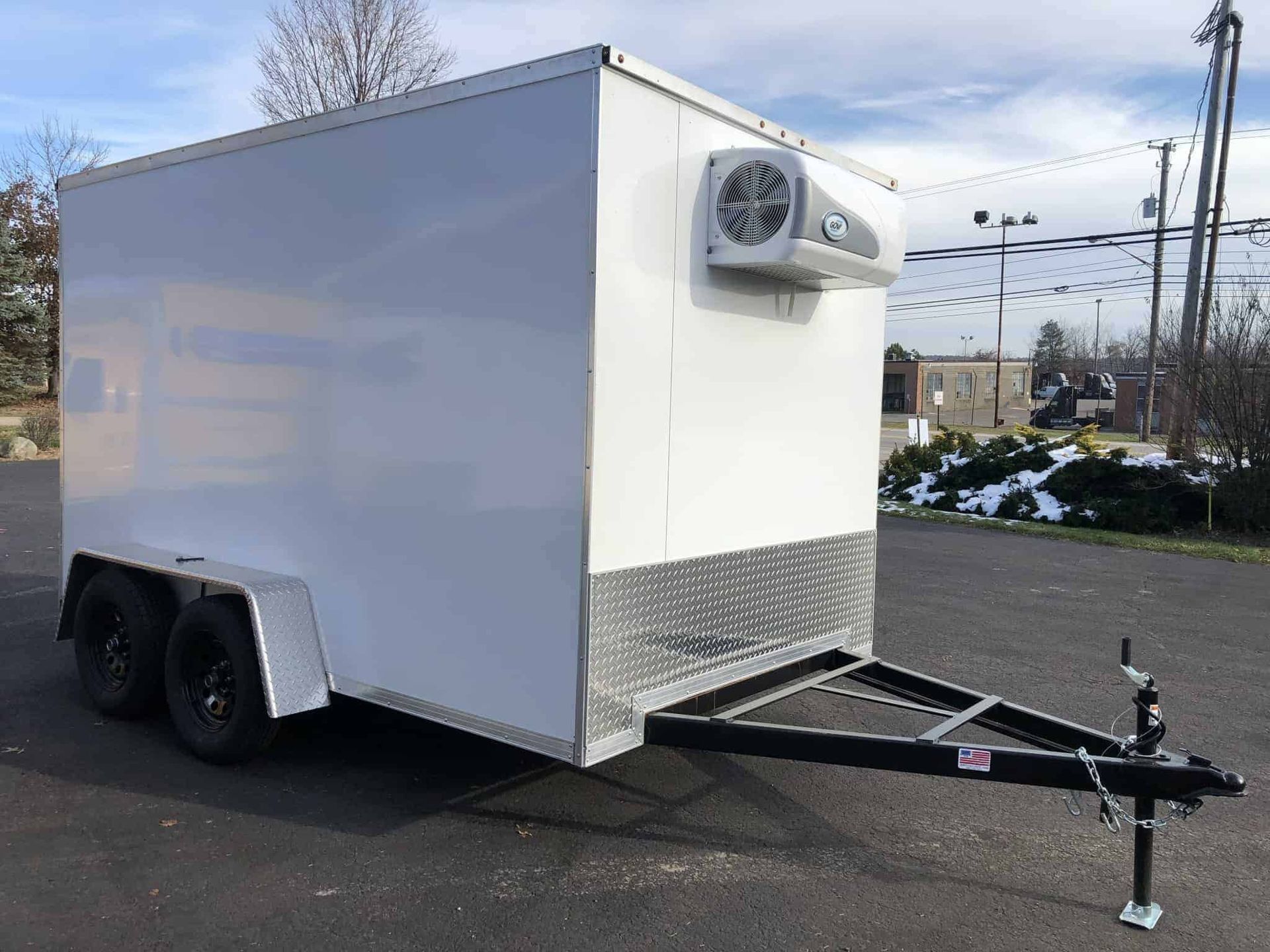 White refrigerated cargo trailer with black tires and hitch.