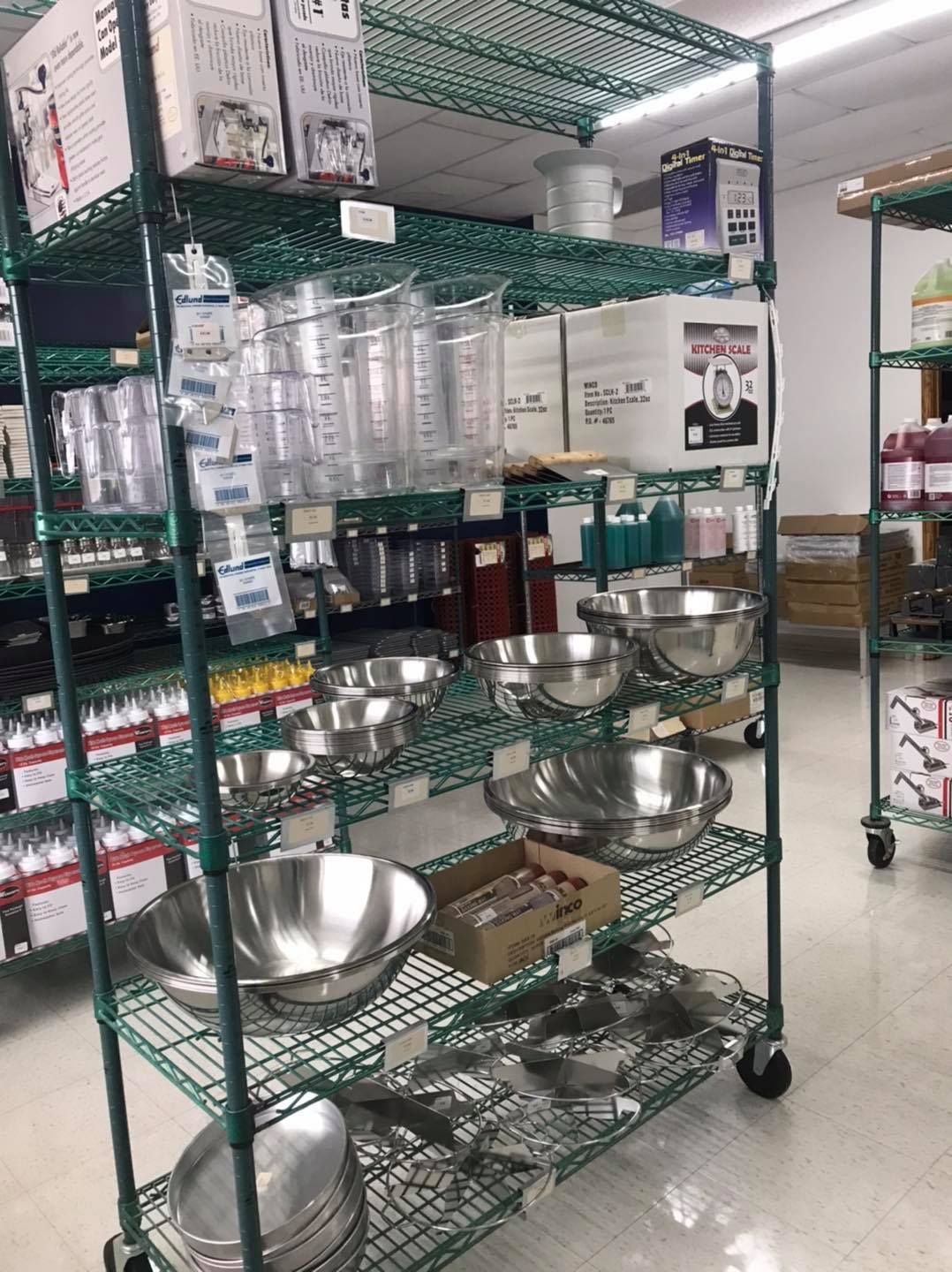 Metal shelving unit displays commercial kitchen supplies in a store.