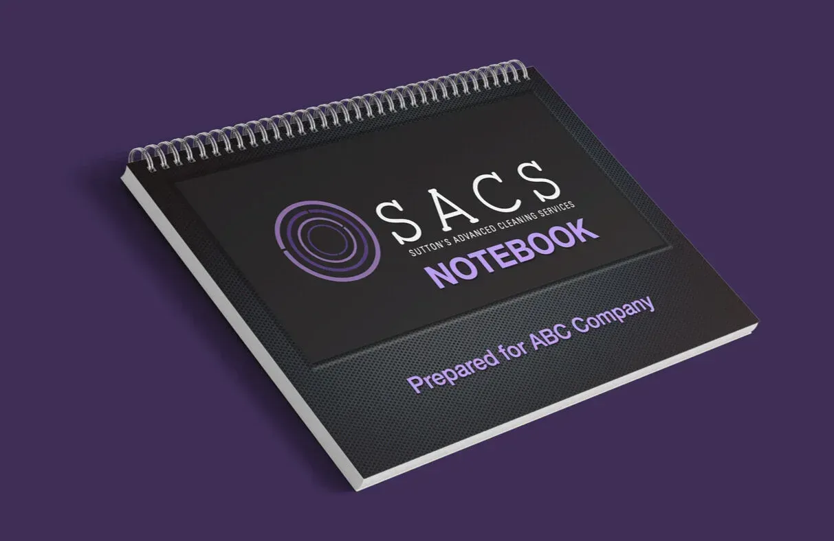 Purple spiral-bound SAS notebook on a dark purple background.