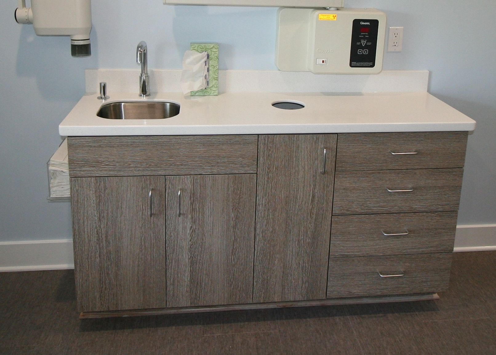 Dental cabinet with sink, cabinets, and drawers in a clinic.
