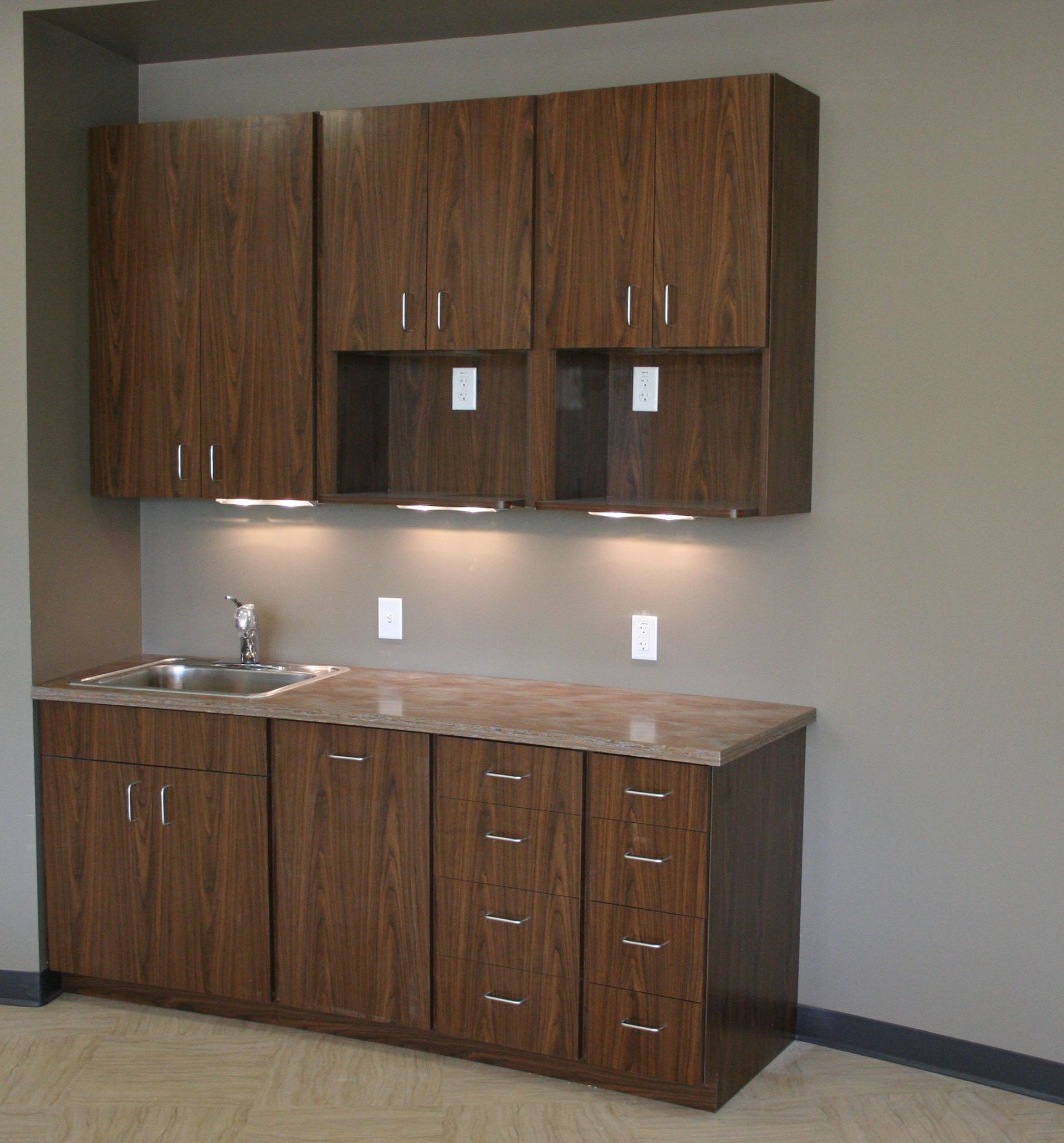 Brown wooden cabinets with a sink and countertop.