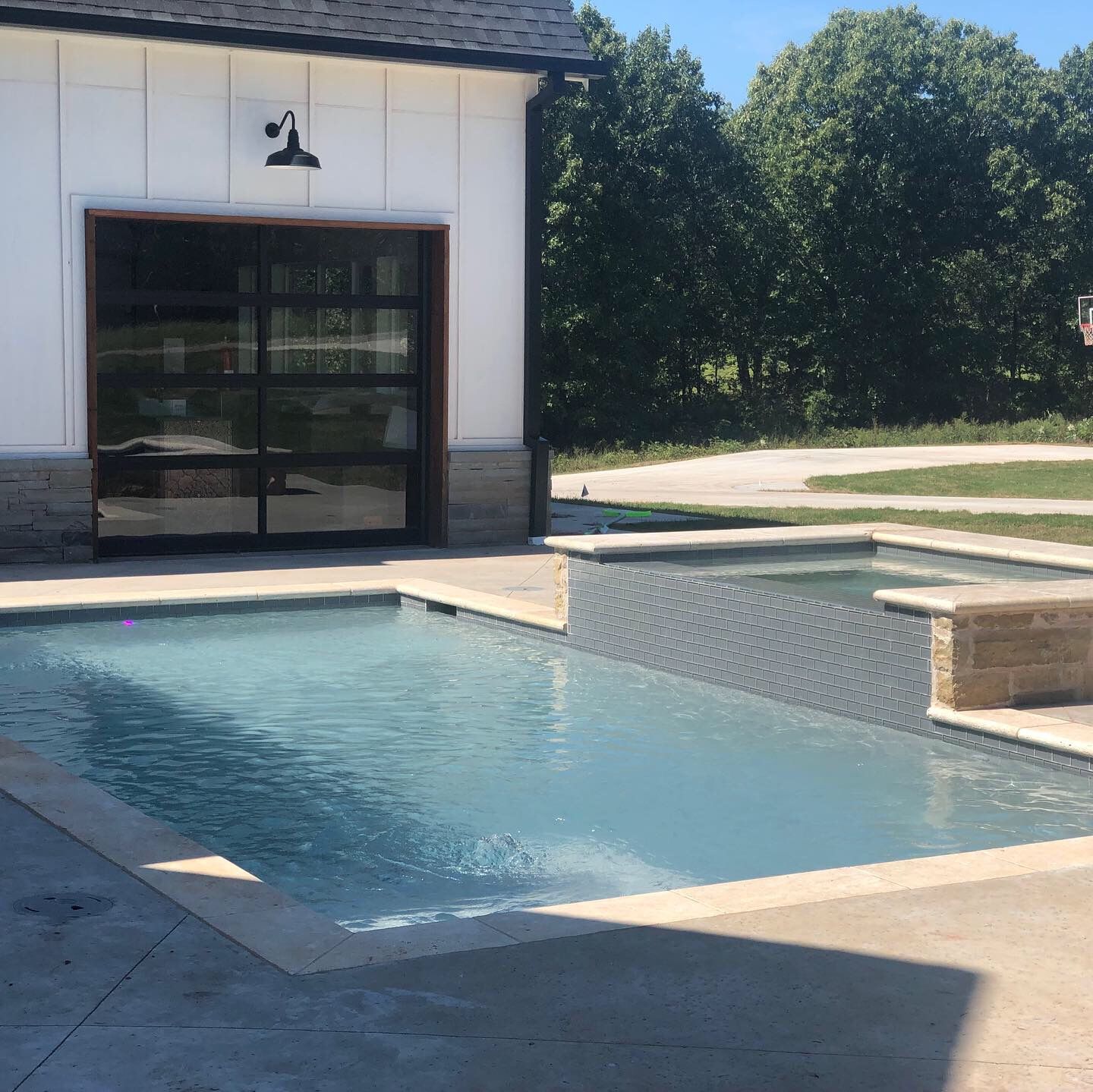 a large swimming pool in front of a white building