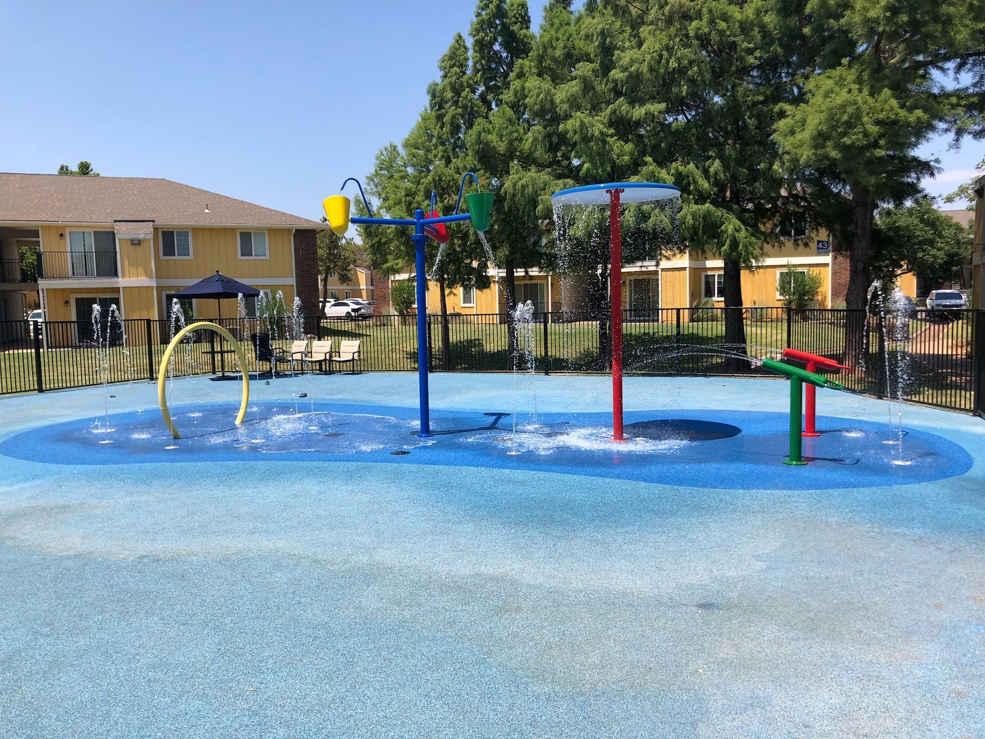 a water park with a building in the background and trees in the foreground
