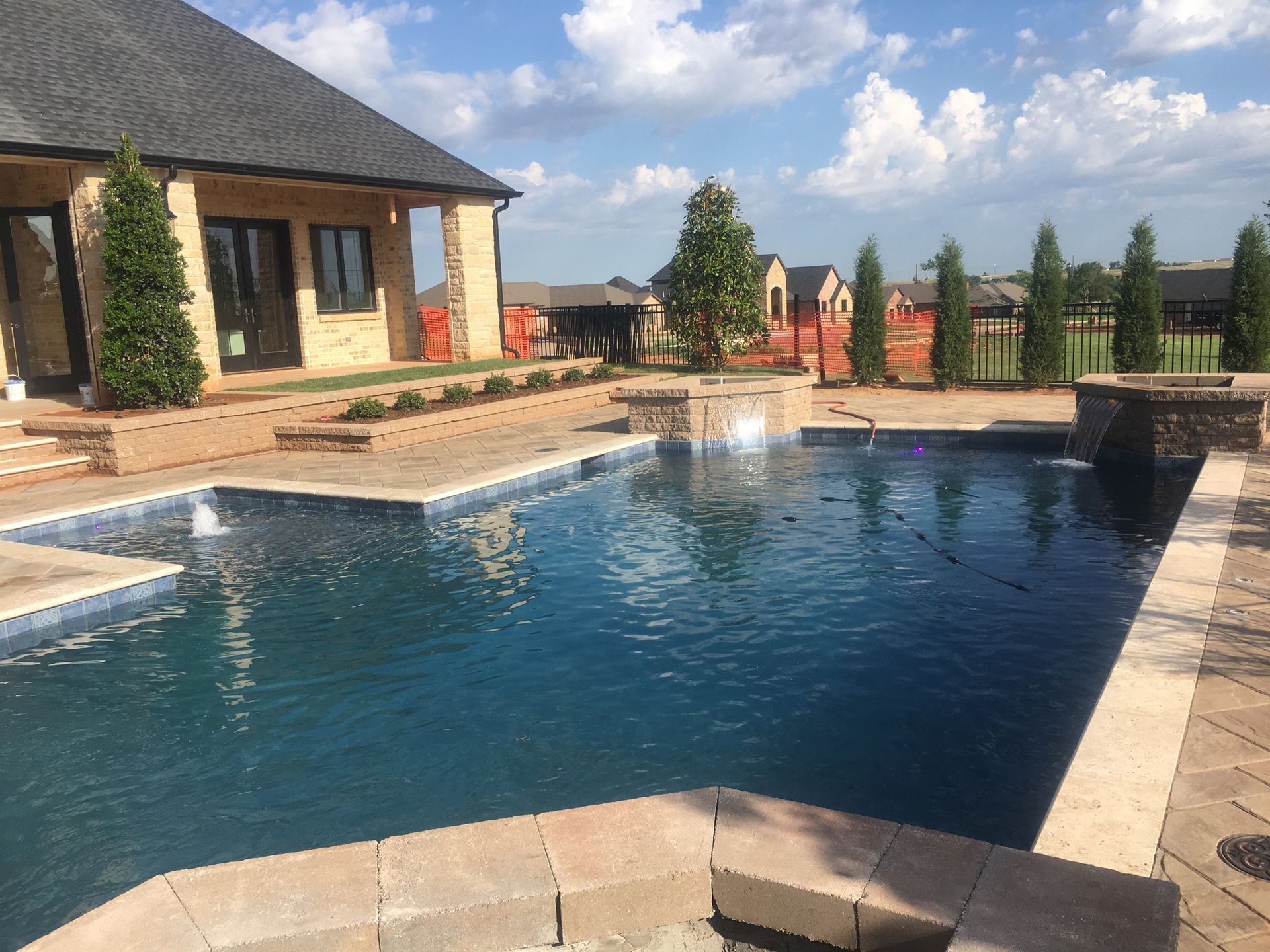 there is a large swimming pool in the backyard of a house