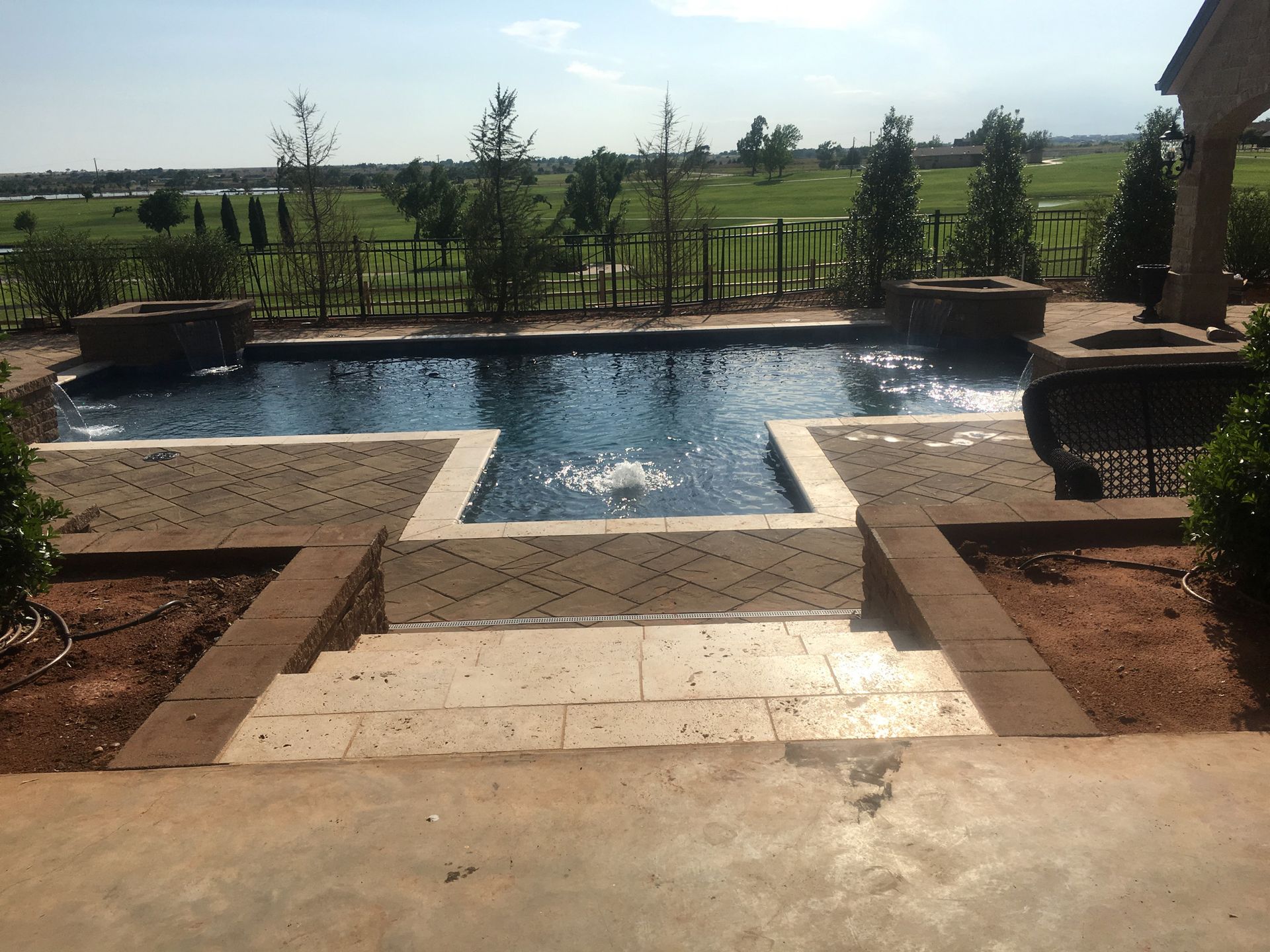 a large swimming pool with stairs leading up to it