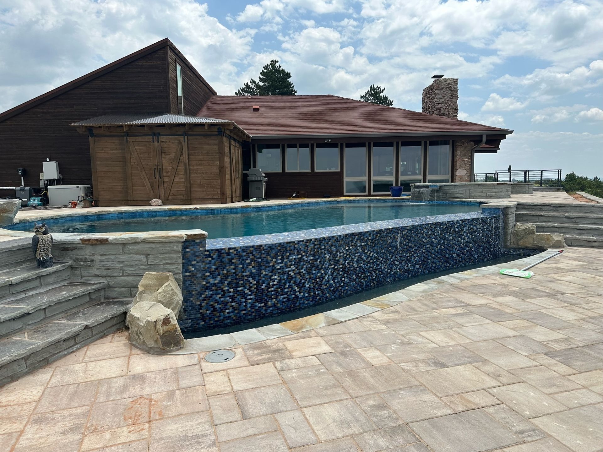 a large house with a large swimming pool in front of it