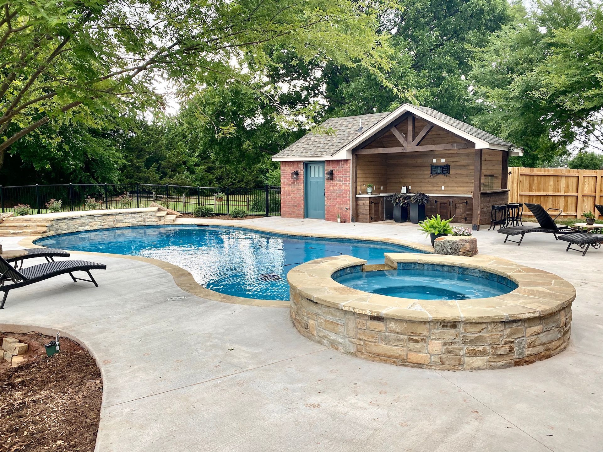 a large swimming pool with a hot tub in the middle of it