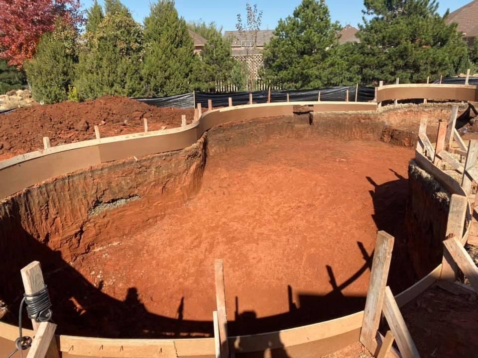 a large pool is being built in the backyard of a house