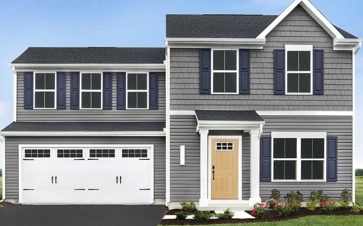 Two-story gray house with blue shutters, tan front door, and attached garage.