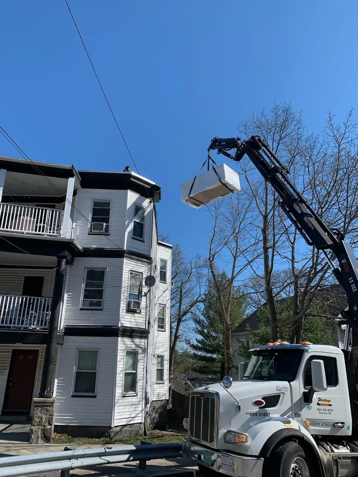 a crane is lifting a box into a building .