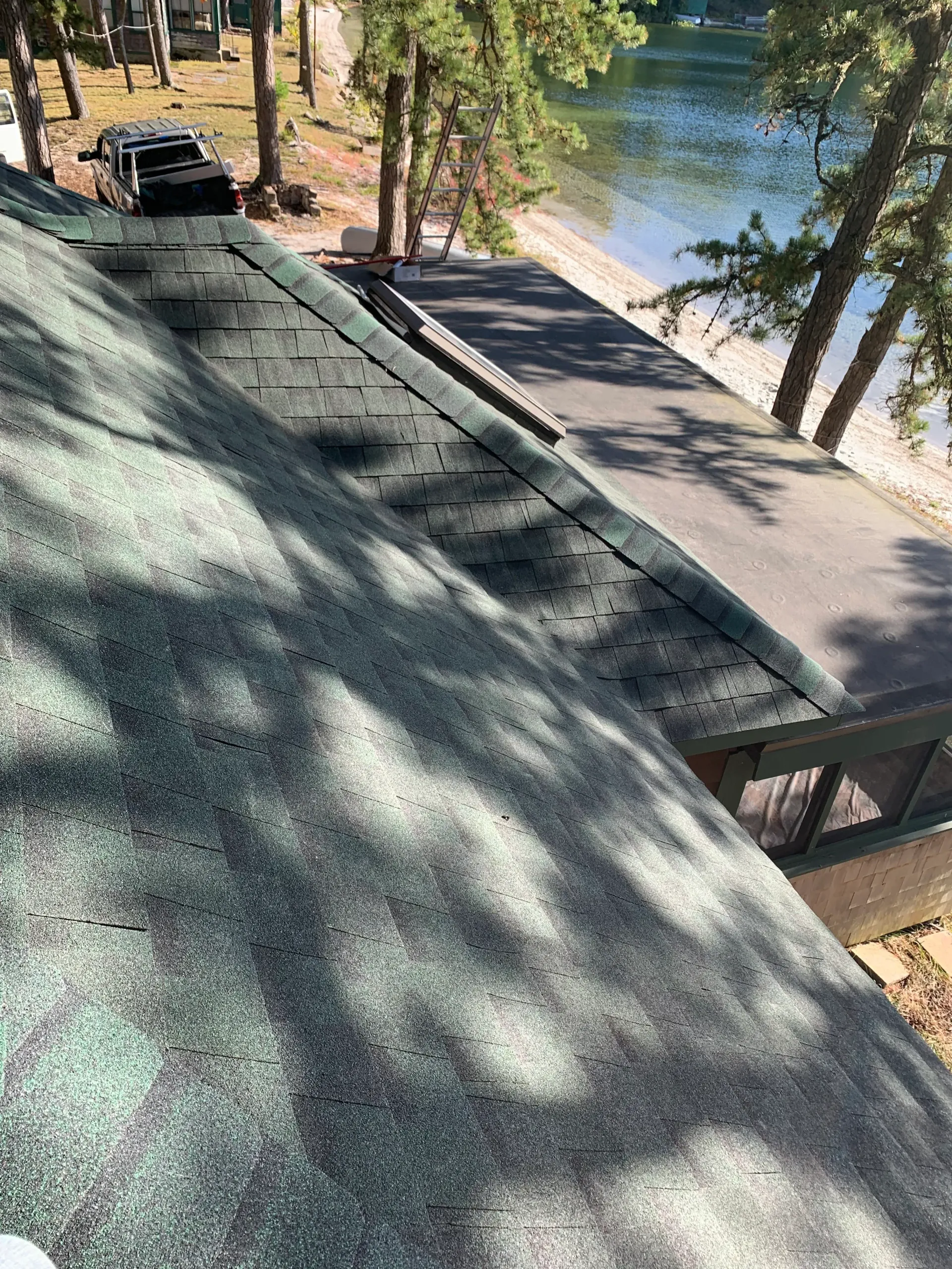 a roof with a view of a lake and trees .