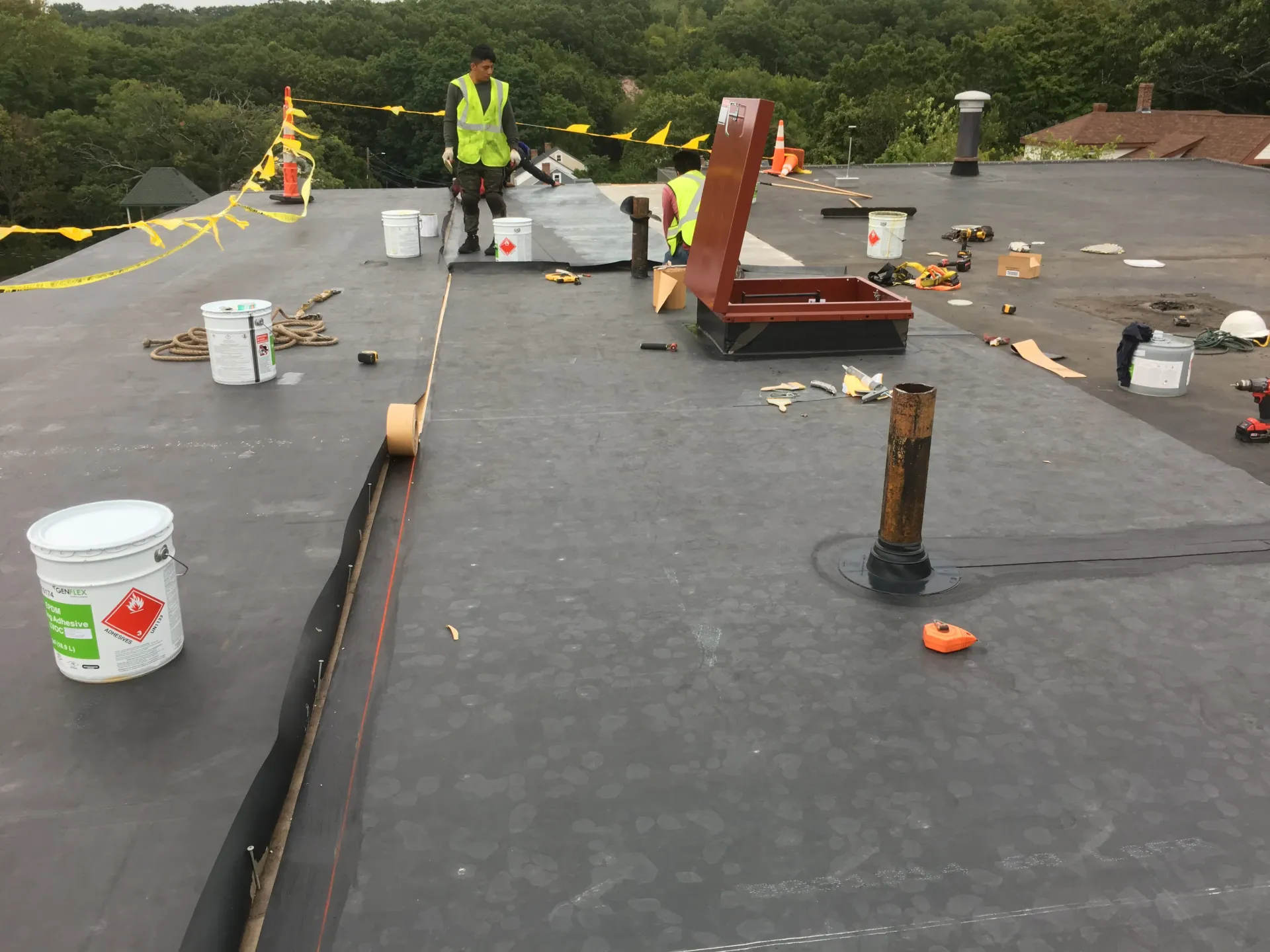 a man is standing on the roof of a building .