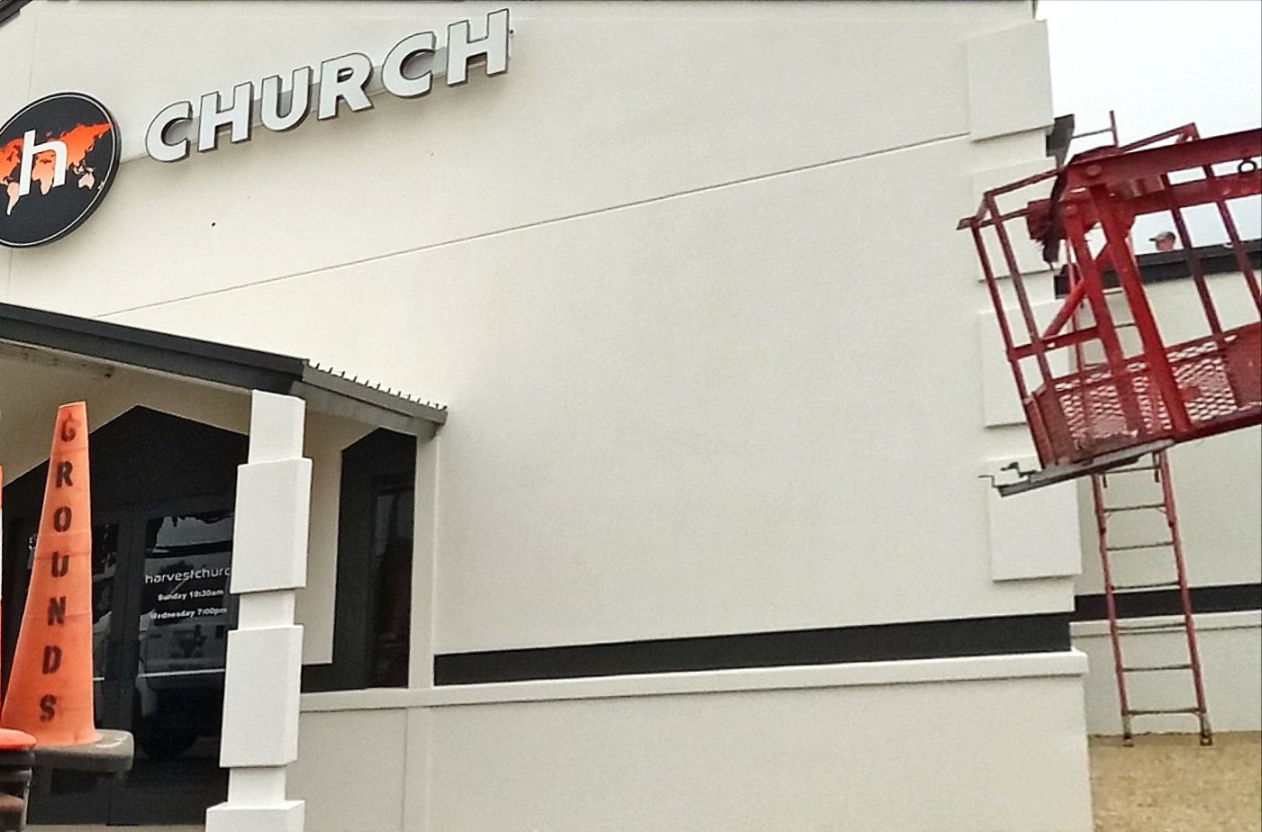 Exterior of a church building with a lift used for maintenance.