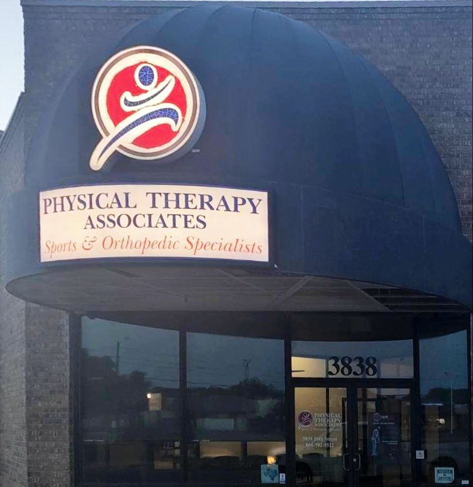 Physical Therapy Associates storefront with blue awning and sign