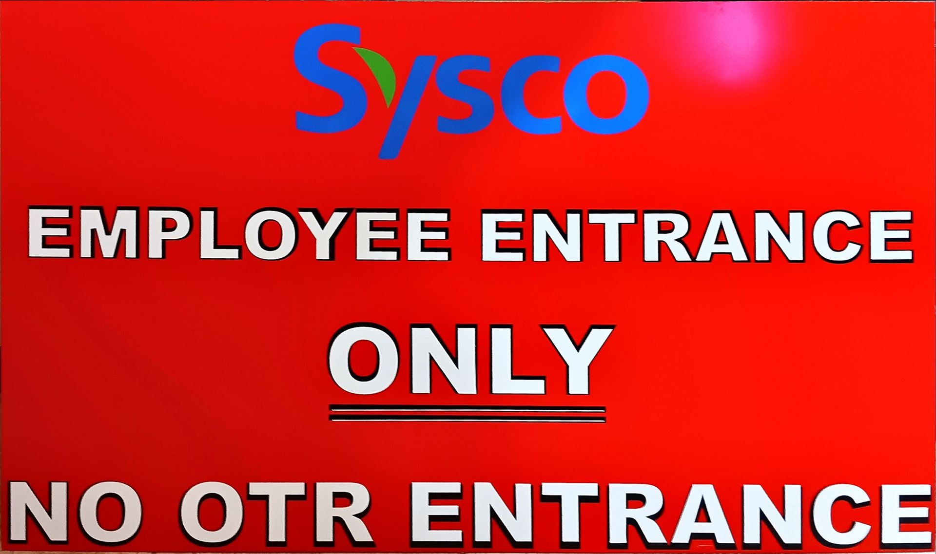 Red sign: Sysco logo