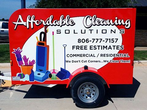 A red trailer advertising affordable cleaning solutions