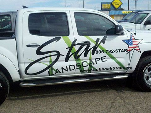 A white truck with the word star landscape on the side