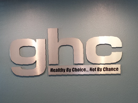 A sign that says ghc healthy by choice not by chance