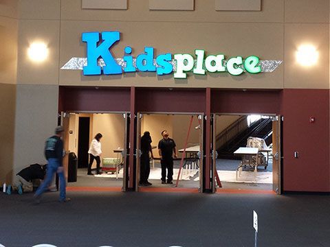 A group of people standing in front of a kids place