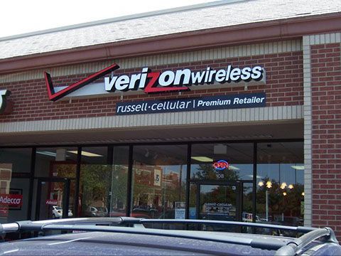 A car is parked in front of a verizon wireless store