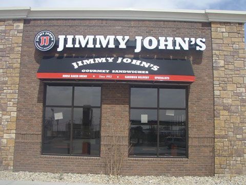 Jimmy john 's gourmet sandwiches is located in a brick building